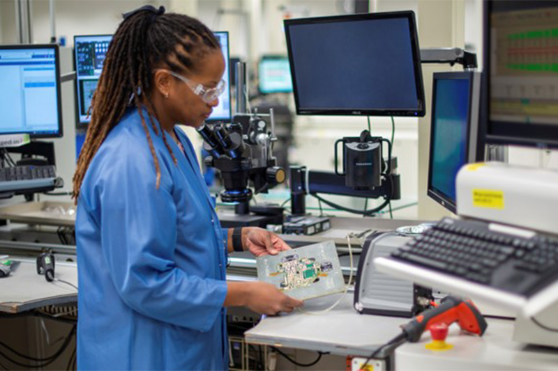 Electrical Assembler working in a clean room with high-tech equipment