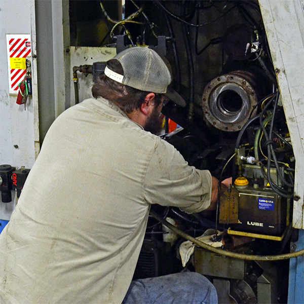 Industrial Machine Mechanic working on equipment in Nacogdoches TX manufacturing plant