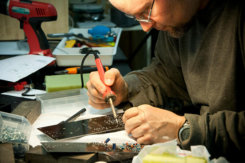 Electrical assembler working with soldering circuit board