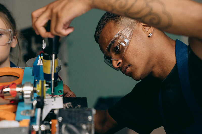 A student learning about career opportunities for electrical and electromechanical assembling with hands on work experience