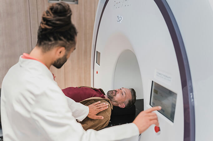 MRI technologist and patient use CT machine