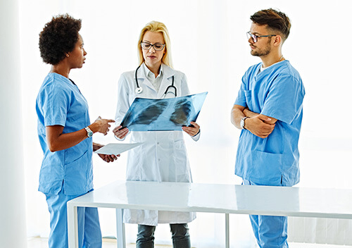 Doctor and radiology techs examine x ray