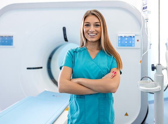 Female CT tech or radiologist works with MRI machine at clinic