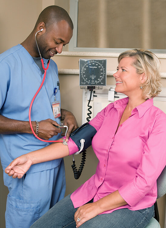 lvn lpn nurse takes patients blood pressure